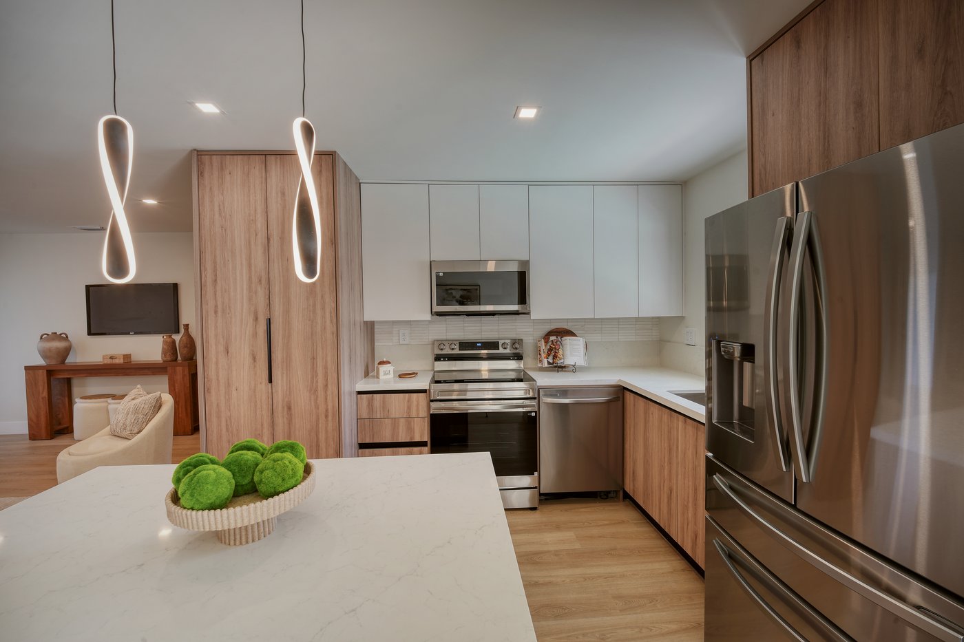 Two sculptural pendant lights suspended over a kitchen island