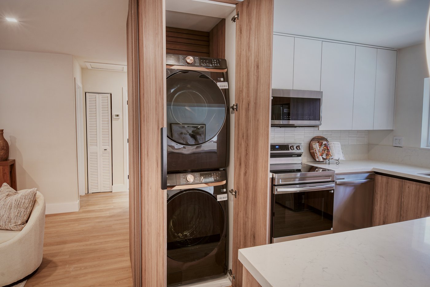 Tall walnut cabinet concealing a stacked washer and dryer